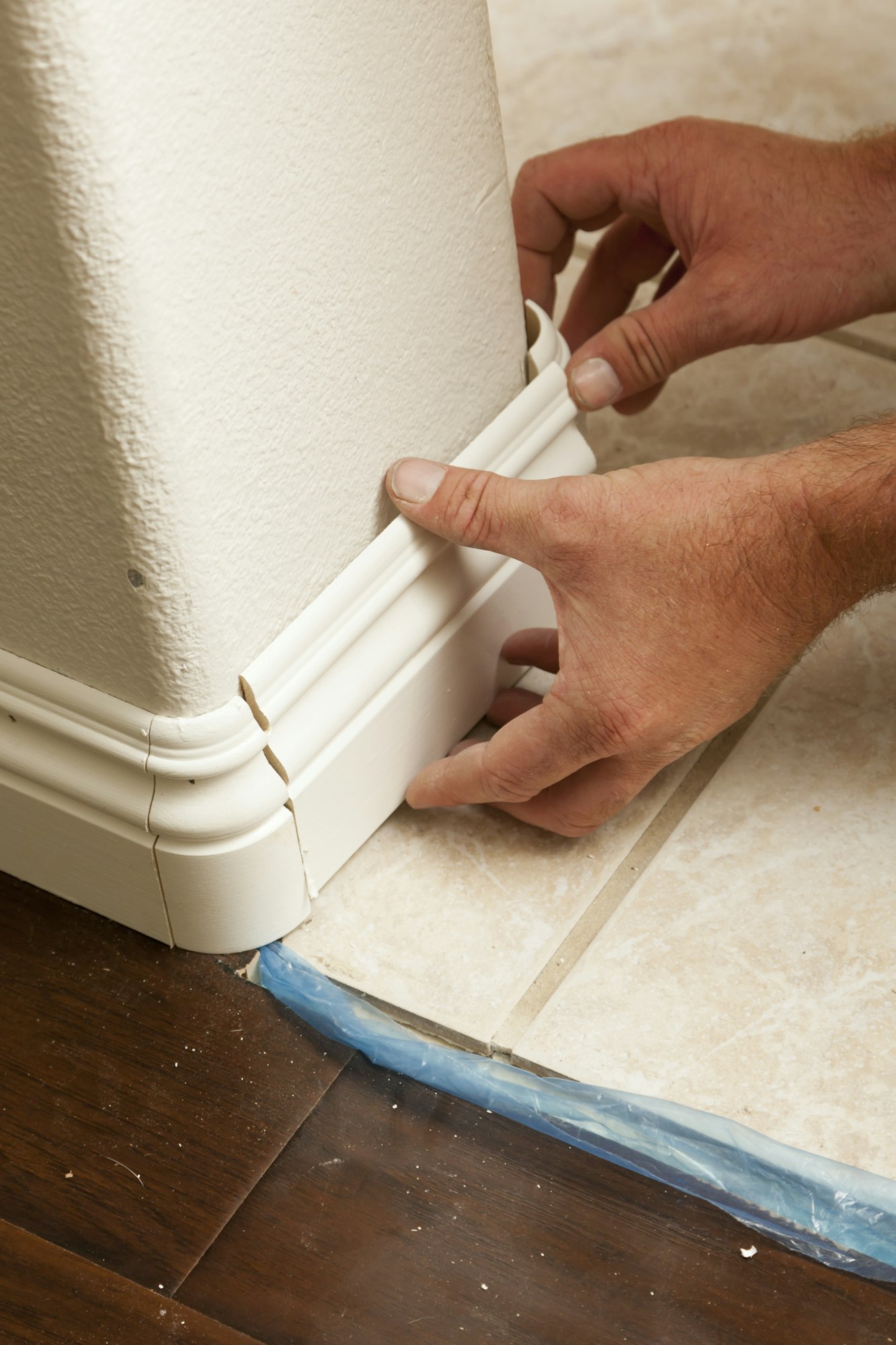 Contractor Installing New Baseboard with Bull Nose Corners In House