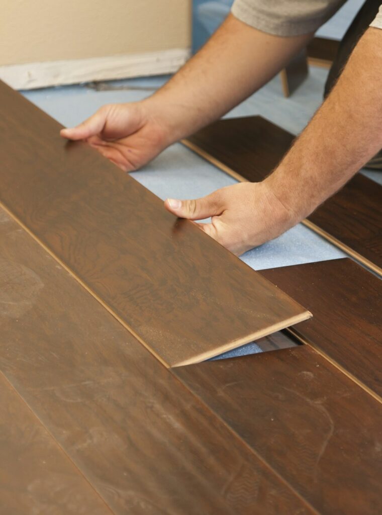 Man Installing New Laminate Wood Flooring